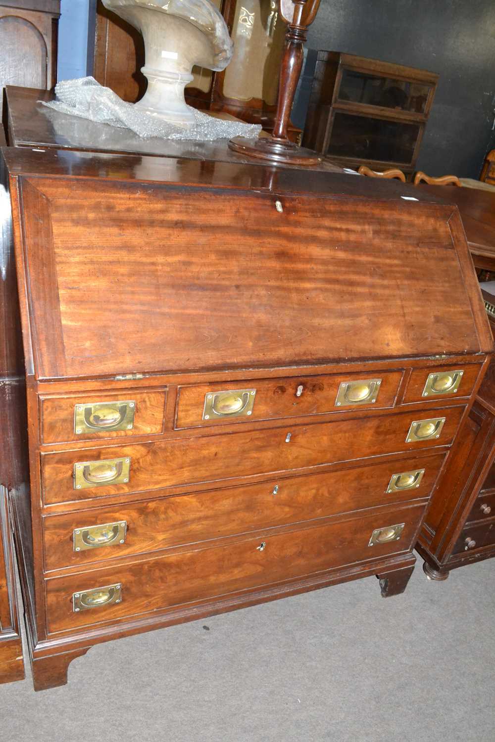 A Georgian mahogany bureau of typical form with full front, fitted interior and a base with three