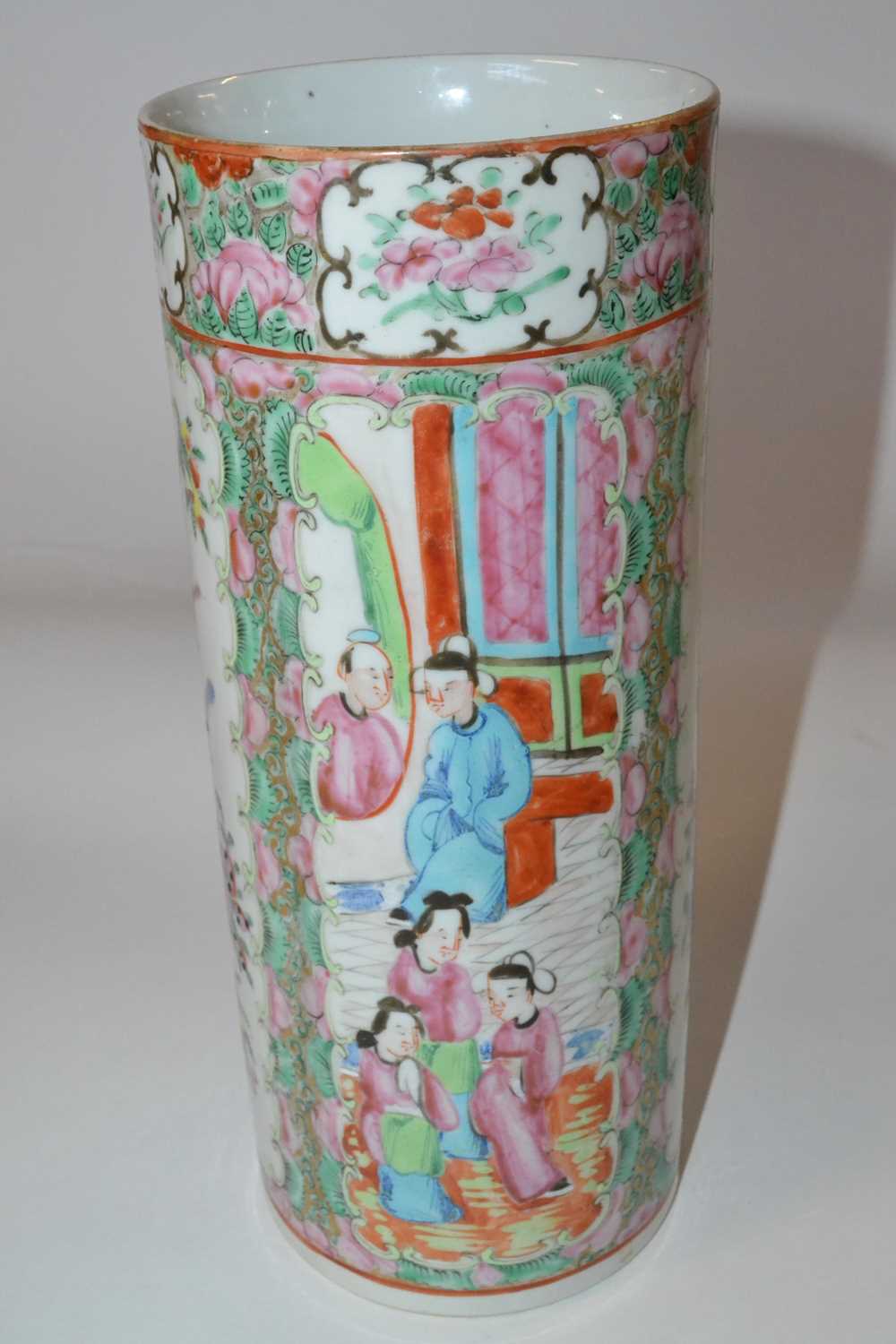 A late 19th Century Cantonese porcelain cylindrical vase, decorated in typical fashion with panels