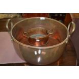 A large Victorian circular copper double handled pan, 44cm diameter together with another smaller (