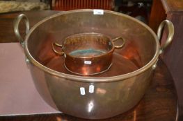 A large Victorian circular copper double handled pan, 44cm diameter together with another smaller (