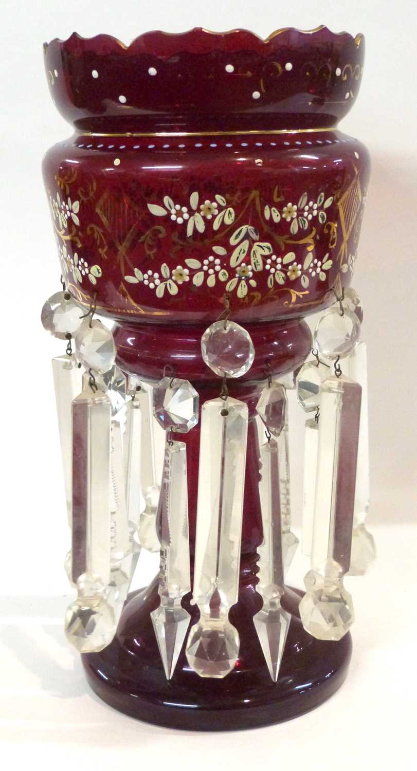 A cranberry glass table lustre with painted flowers, 38cm high