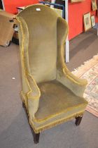 A narrow Georgian style wing back armchair, 118cm high