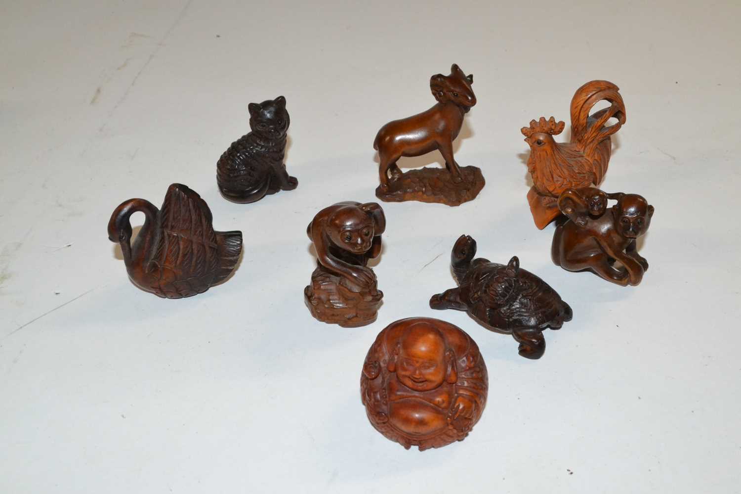 Plastic bag containing a quantity of wooden Netsuke of various animals, tortoise, monkeys etc