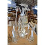 A 20th Century crystal glass chandelier with five scrolled branches, 60cm wide, 85cm high