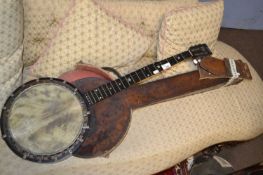 An antique banjo with six strings, stamped to the reverse of the head, J E Dallas Maker, 92cm long