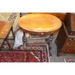 A Victorian walnut veneered sewing table of oval form with hinged lid opening to a fitted interior