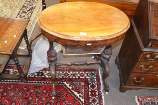 A Victorian walnut veneered sewing table of oval form with hinged lid opening to a fitted interior