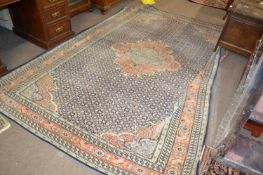 An early 20th Century Persian wool carpet with intense geometric pattern in faded blue, pink and