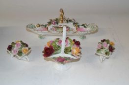 A box containing Royal Albert porcelain flowers and two wheelbarrows and further porcelain tray