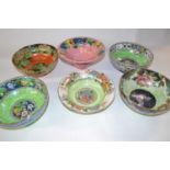 A group of six Maling lustre ware bowls with various floral designs including a ribbed bowl, the