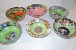 A group of six Maling lustre ware bowls with various floral designs including a ribbed bowl, the
