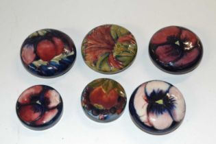 A group of six early 20th Century Moorcroft pottery lids, one with a cornflower design, others