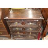 A 17th Century oak chest of drawers with panelled ends and four drawers with carved decoration