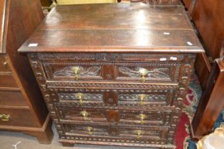 A 17th Century oak chest of drawers with panelled ends and four drawers with carved decoration