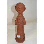 A stone ware terracotta figure of a young child with bird, on circular base, 38cm high