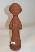 A stone ware terracotta figure of a young child with bird, on circular base, 38cm high