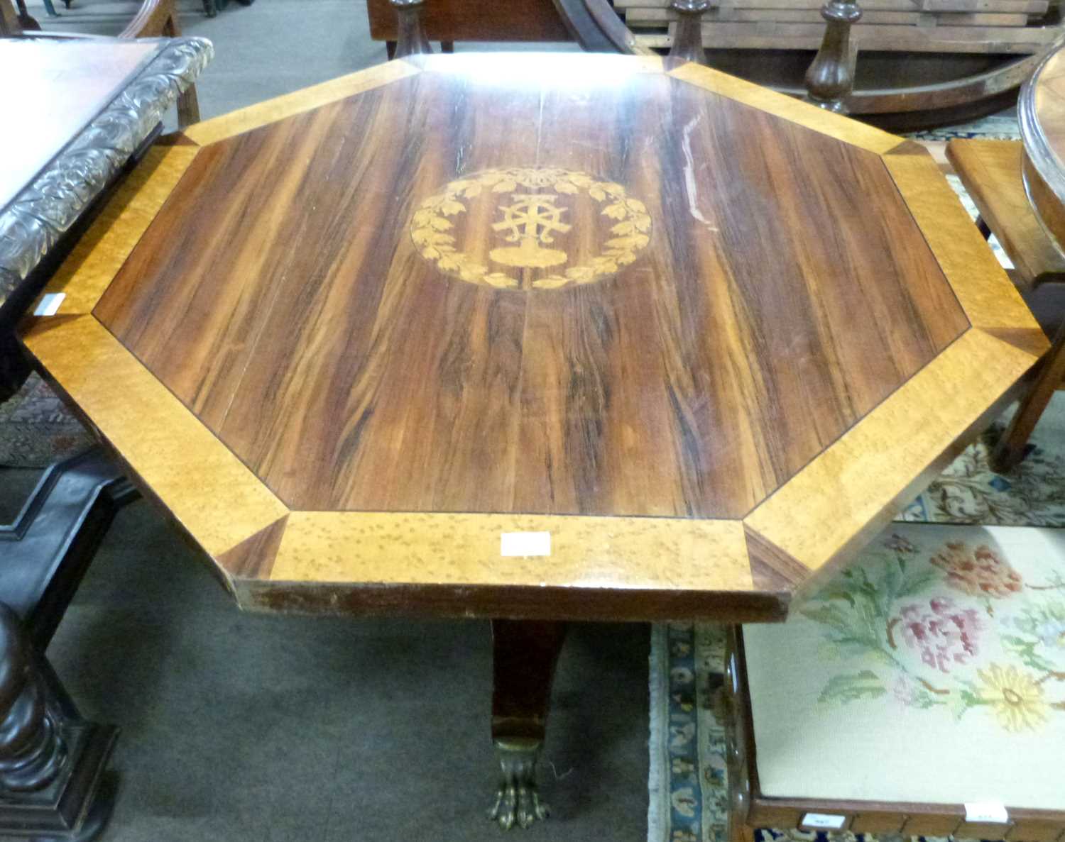 An unusual 19th Century octagonal centre table with inlaid armorial to centre, surrounded by