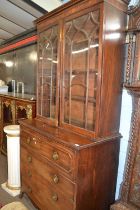 A George III mahogany secretaire cabinet with moulded cornice over two glazed doors and a base