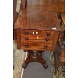 An early Victorian mahogany drop leaf small centre or sewing table raised on a turned column with