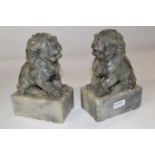 A pair of Oriental soapstone lions on rectangular bases, 15cm high