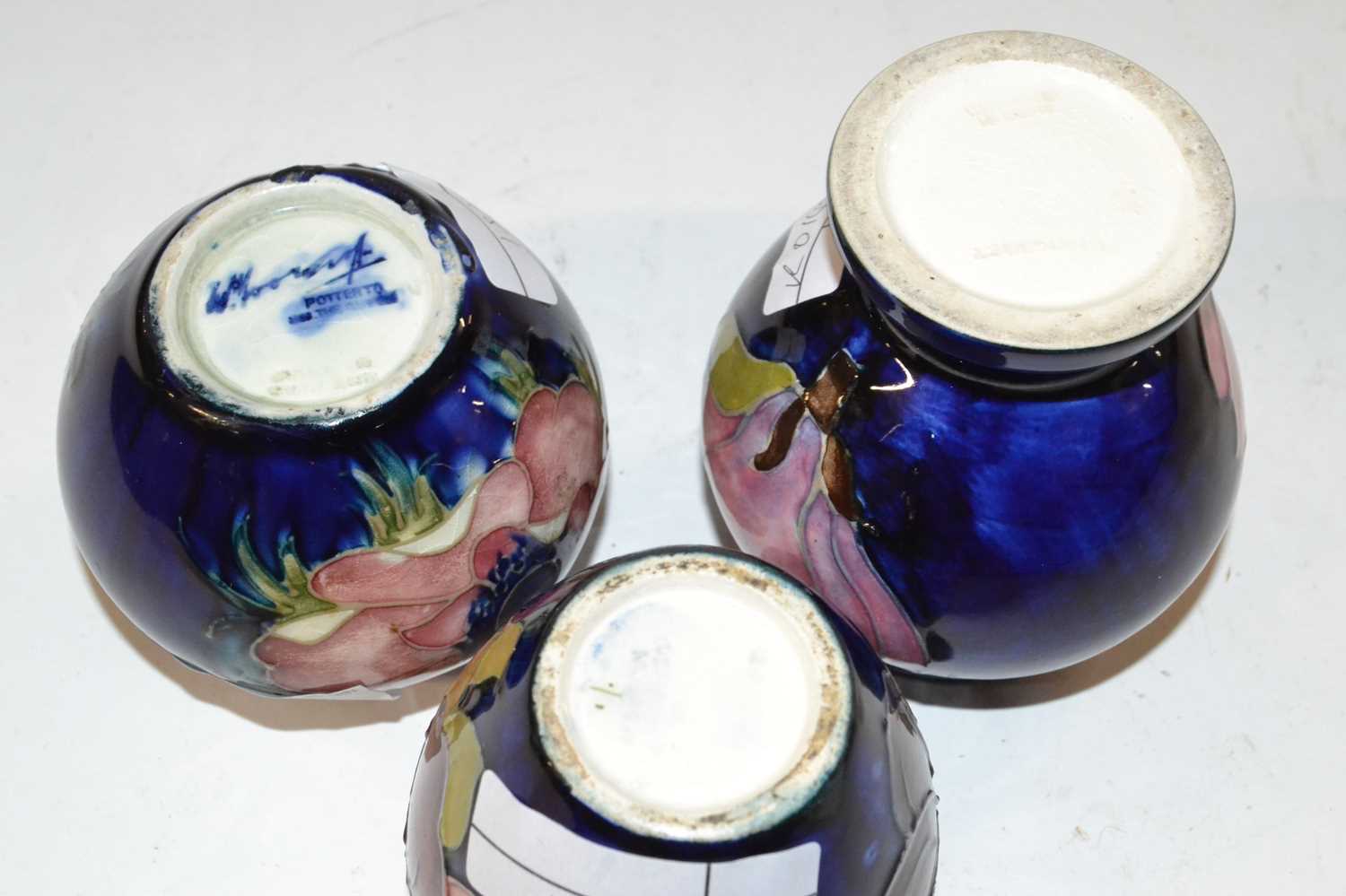 A group of three small Moorcroft vases, all with hibiscus or anemone designs on a blue ground - Image 2 of 2
