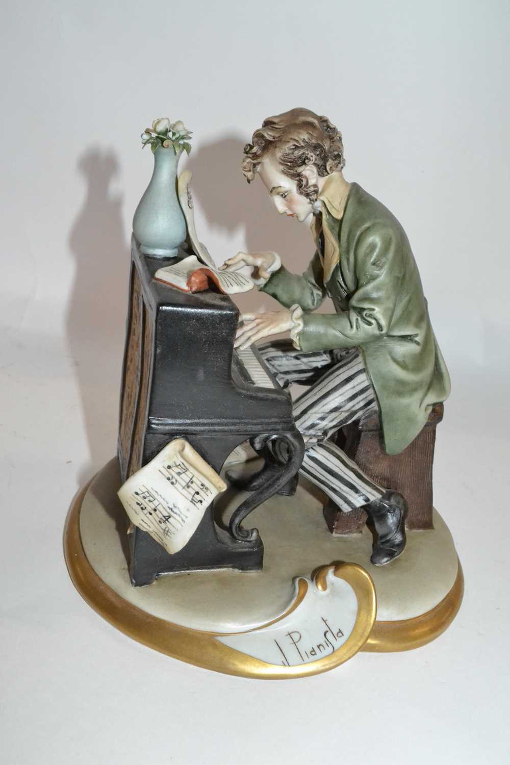 Continental porcelain model of a piano player