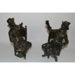 Two bronzed Spelter figures, one of a Cavalier seated and a further gentleman seated smoking a pipe,