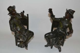 Two bronzed Spelter figures, one of a Cavalier seated and a further gentleman seated smoking a pipe,