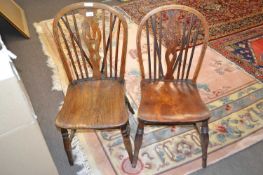Two Victorian stick back kitchen chairs with elm seats and turned legs, one with a pierced back