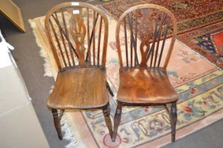 Two Victorian stick back kitchen chairs with elm seats and turned legs, one with a pierced back