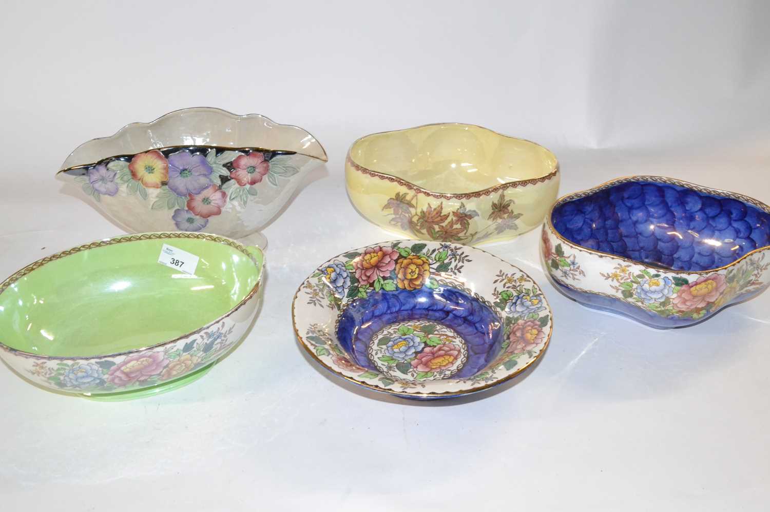 A group of five Maling lustre bowls all with various floral designs, largest 29cm diameter