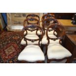 A set of six Victorian mahogany balloon back dining chairs with carved floral decoration and front