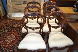 A set of six Victorian mahogany balloon back dining chairs with carved floral decoration and front