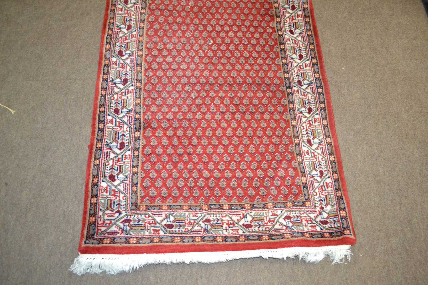 An Iranian wool runner carpet decorated with a large repetitive central panel with leaf decoration - Image 2 of 2