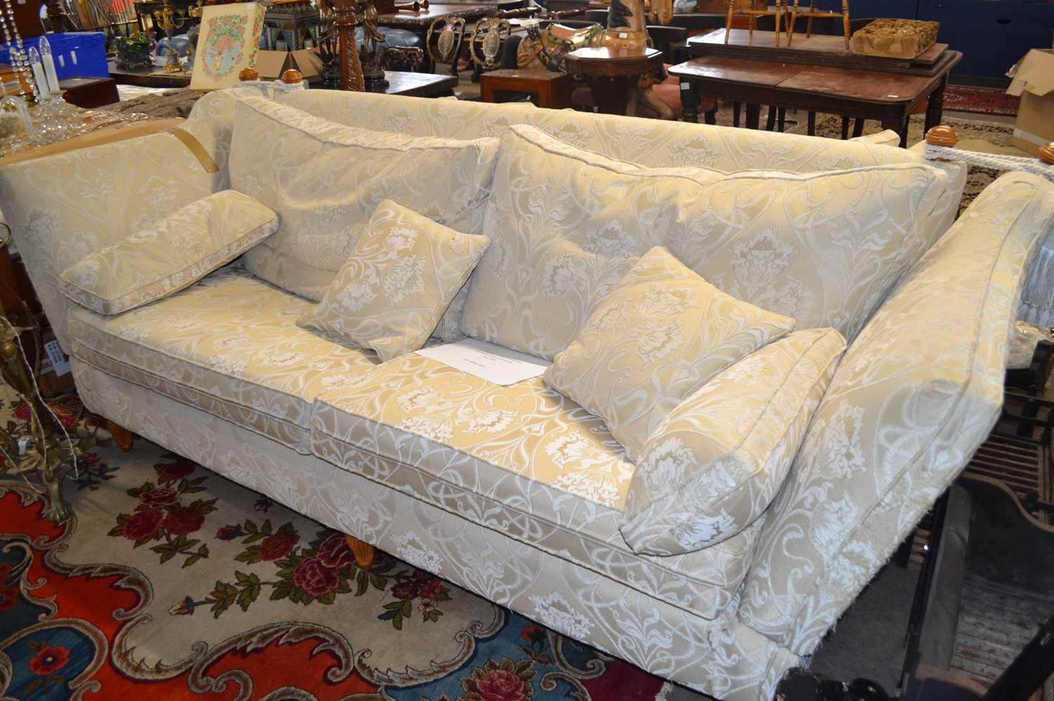 A large modern Knowle style sofa with drop ends and floral loose cushions, 250cm wide