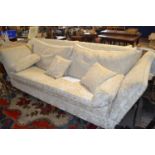 A large modern Knowle style sofa with drop ends and floral loose cushions, 250cm wide