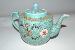 A Chinese porcelain teapot, late 19th Century, the turquoise ground with polychrome design of