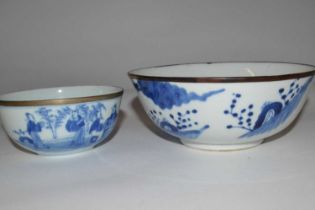 An Oriental porcelain bowl, possibly Japanese, with blue and white design and metal rim together