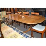 A mahogany twin pedestal extending dining table in the George III style , each pedestal with a