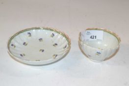 A late 18th Century Lowestoft porcelain tea bowl and saucer of fluted form decorated with flower