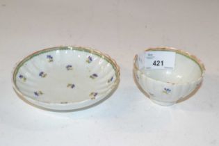 A late 18th Century Lowestoft porcelain tea bowl and saucer of fluted form decorated with flower
