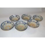 Six Oriental pottery bowls with painted blue and white design