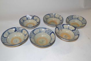 Six Oriental pottery bowls with painted blue and white design