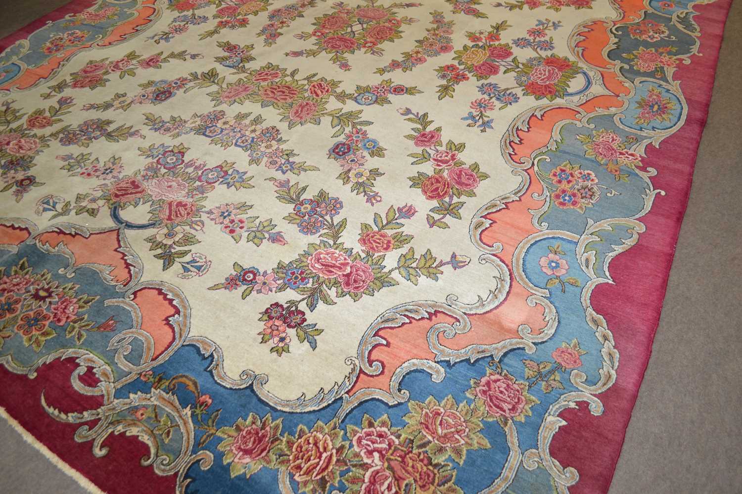 An early 20th Century wool carpet with all over rose decoration and large central cartouche - Image 2 of 3