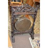 A large late 19th or early 20th Century Chinese hardwood framed brass dinner gong, the frame with
