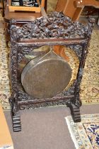 A large late 19th or early 20th Century Chinese hardwood framed brass dinner gong, the frame with