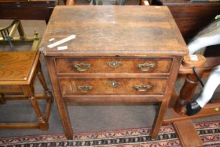 A Georgian walnut veneered two drawer side table or low boy with pierced handles and square legs,