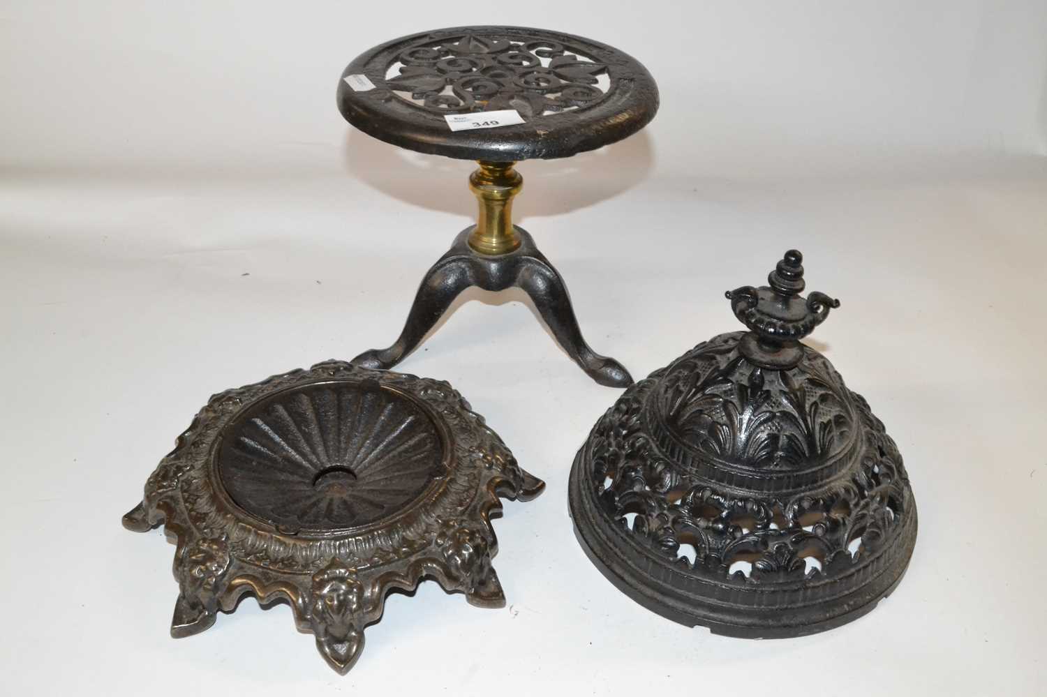 Mixed Lot: A Victorian cast iron spitoon together with a further circular tripod base trivet and a