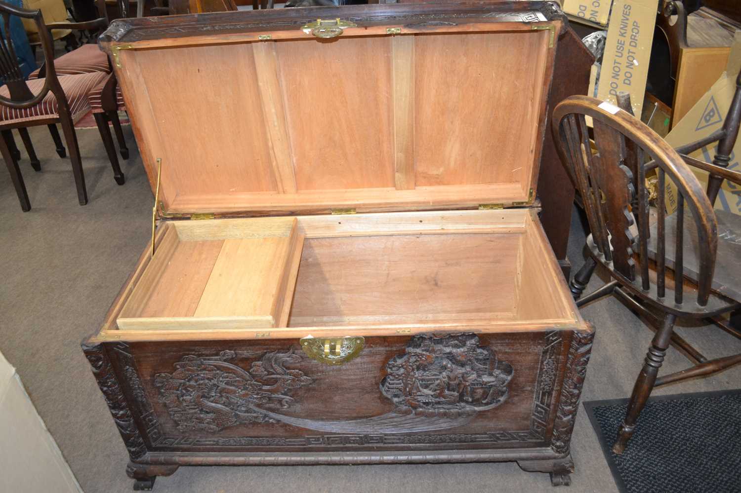 A 20th Century Chinese camphor wood blanket box of hinged rectangular form decorated with carved - Image 2 of 2