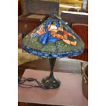 A reproduction Tiffany style table lamp with floral decorated shade, 62cm high